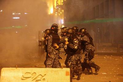 Riot police walk together during a protest in Beirut, Lebanon. Reuters