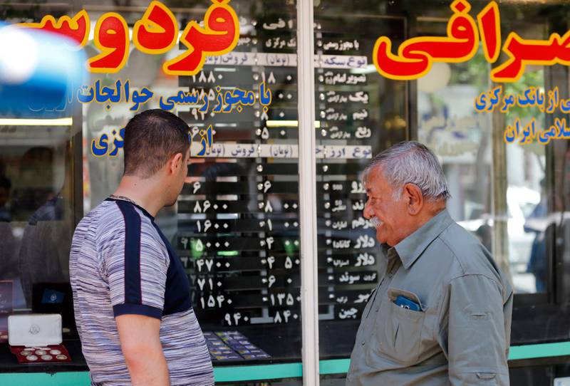 epa06660327 Iranians check the currency rate around an exchanges shop in Tehran, Iran, 10 April 2018. Media reported that President Hassan Rouhani and his cabinet have been criticized for the slide of the currency, as the US dollar is risen by 40 percent against the rial, which comes as US President Donald Trump threatens to pull out of a nuclear deal and re-impose potentially crippling sanctions. Iran moved to enforce a single exchange rate to the dollar, banning all unregulated trading after the country's currency, the rial felt in low against US dollar.  EPA/ABEDIN TAHERKENAREH