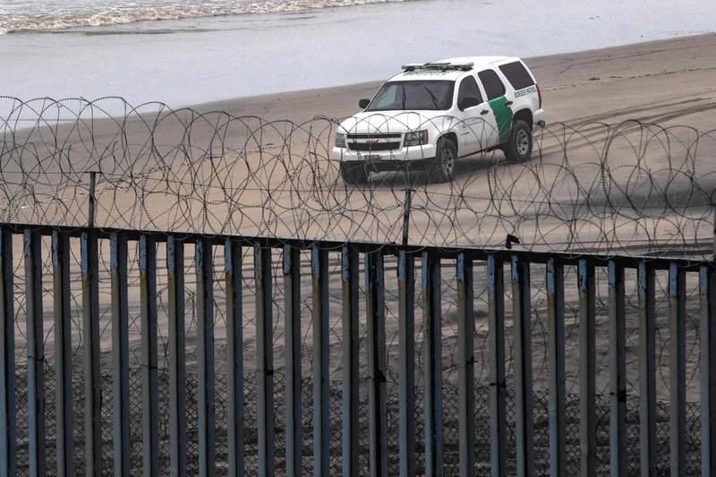 A Border Patrol unit remains near a section of reinforced US-Mexico border fence seen from Tijuana, Baja California state, Mexico.  AFP