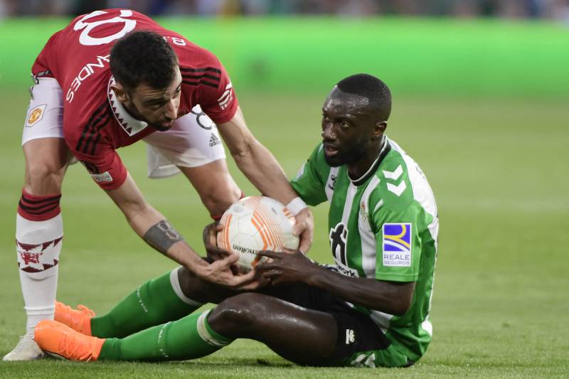United midfielder Bruno Fernandes (L) tries to take the ball off Real Betis defender Youssouf Sabaly. AFP