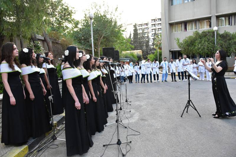 Ghada Harb, the leader of the Syrian Ghardenia female choir, and the singers of her group perform outside of the Children's Hospital in Damascus, Syria.  EPA