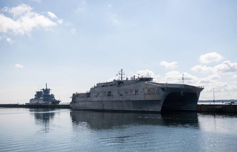 epa07632457 The USNS 'Carson City' of the United States of America and the German frigate 'Hamburg' (L) of the German in the port of Eckernförde, northern Germany, 7 June 2019. The ship will take part of the annual multi-national military exercise 'BALTOPS' (Baltic Operations) in the Baltic Sea in the next week. More than 50 ships from 15 different NATO countries will join the exercise.  EPA-EFE/DAVID HECKER