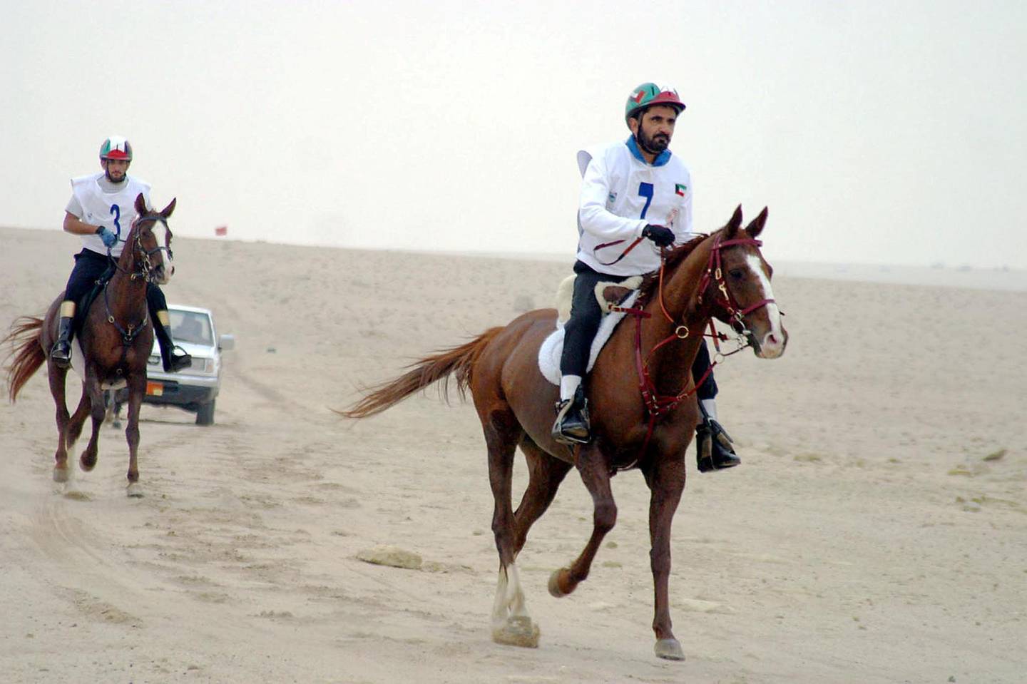 Dubai Crown Prince Sheikh Mohammed bin Rashed al-Maktum (R) and his son Sheikh Hamdan take part 04 December 2003 in the Horses Capacity and Endurance Championship in Kuwait City. Many well-known jockeys from the United Arab Emirates and Kuwait are competing in the event.     AFP PHOTO/Yasser AL-ZAYYAT (Photo by YASSER AL-ZAYYAT / AFP)
