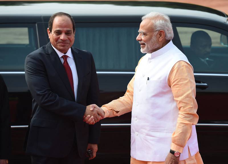 India's Prime Minister Narendra Modi (R) shakes hands with President of the Arab Republic of Egypt Abdel Fattah El Sisi. AFP