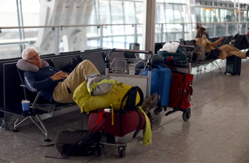 A waiting passenger decides to get some sleep in Terminal 5. Reuters