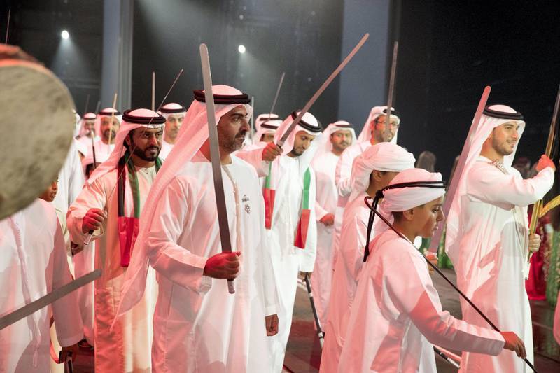 ABU DHABI, UNITED ARAB EMIRATES - December 02, 2017: HH Sheikh Zayed bin Mohamed bin Hamad bin Tahnoon Al Nahyan (R) and HH Sheikh Hamed bin Zayed Al Nahyan, Chairman of the Crown Prince Court of Abu Dhabi and Abu Dhabi Executive Council Member (2nd R), dance during the 46th UAE National Day celebrations at Mushrif Palace. Seen with HH Sheikh Abdullah bin Mohamed bin Khaled Al Nahyan (back L).
( Hamad Al Kaabi / Crown Prince Court - Abu Dhabi )
---