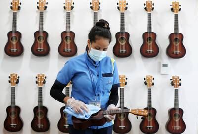 Sangita cleaning ukuleles in the music room at the Swiss International Scientific School. Chris Whiteoak / The National