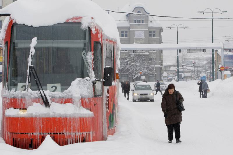 A Bosnian walks past a frozen tram in the Bosnian capital of Sarajevo, on Saturday, Feb. 4, 2012. Eastern Europe's unrelenting and deadly cold snap produced another heavy snowfall in the Balkans on Saturday, trapping people in their homes and cars, causing power outages, and closing airports, railway stations and bus services. In Bosnia, about 30 people whose vehicles were trapped in a tunnel south of Sarajevo called local radio stations to appeal for help, saying they had children with them and were running out of fuel.(AP Photo/Amel Emric) *** Local Caption ***  Bosnia Europe Weather.JPEG-05355.jpg