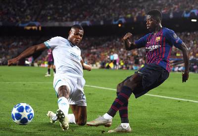 Barcelona's Ousmane Dembele crosses the ball under pressure from PSV Eindhoven's Denzel Dumfries. Getty Images