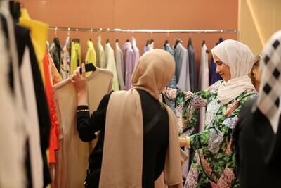 Visitors browse items on display at Dubai Modest Fashion Week.