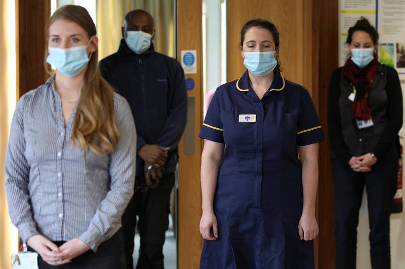 Healthcare workers and staff members observe a minute of silence at the Marie Curie Hospice in Hampstead, in London. Reuters