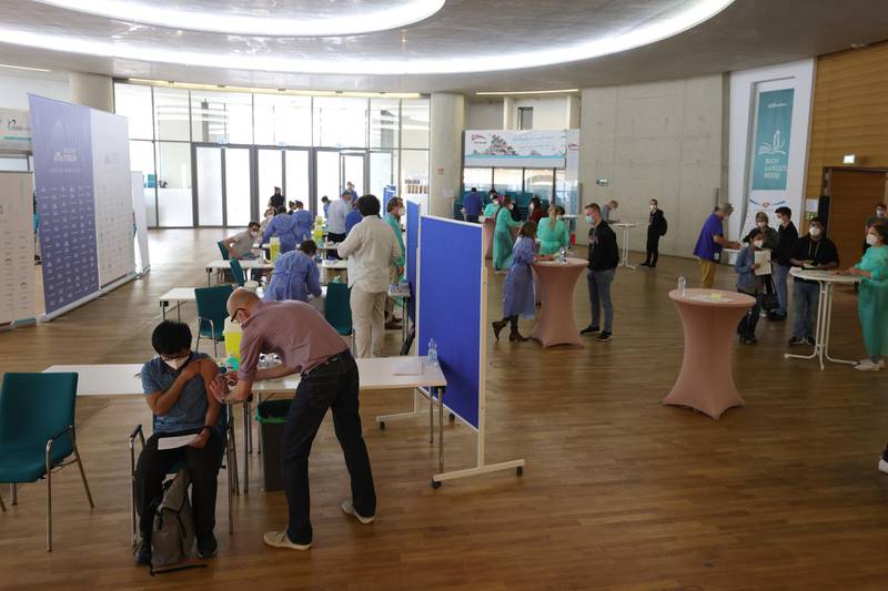 COLOGNE, GERMANY - MAY 09: People receive a corona vaccination with AstraZeneca against Covid-19 inside the city's main mosque, which has temporarily become a mass vaccination center, during the coronavirus pandemic on May 09, 2021 in Cologne, Germany. City authorities are offering more than 1100 doses of the AstraZeneca vaccine at the mosque on a first-come first serve basis for a second day following the accumulation of doses. (Photo by Andreas Rentz/Getty Images)