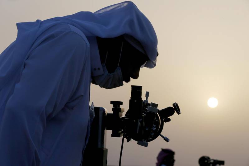 A member of the Moon-sighting committee looks through a telescope near Riyadh, Saudi Arabia, to look for the new crescent moon that will mark the beginning Ramadan the following day. Reuters