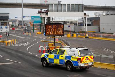 A police car drives past an information sign at the entrance to the Port of Dover. Reuters