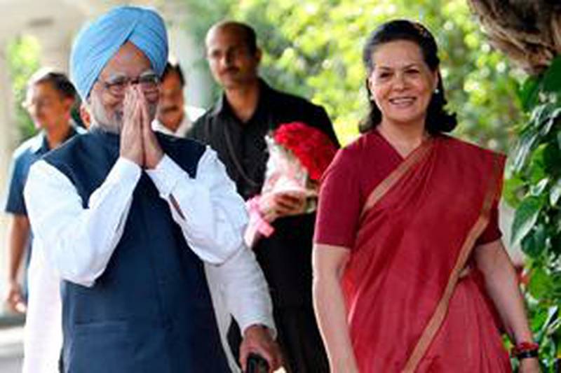 Prime Minister Manmohan Singh and the Congress Party president, Sonia Gandhi, arrive for a press conference at her residence in New Delhi.