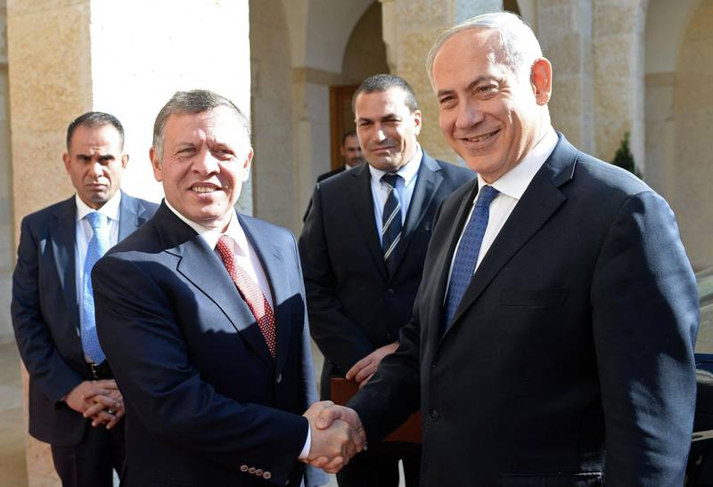 A handout picture released by the Israeli Government Press Office (GPO) shows King Abdullah II of Jordan (R) shaking hands with Israeli Prime Minister Benjamin Netanyahu prior their meeting in Amman on January 16, 2014. Netanyahu made the unannounced visit to neighbouring Jordan for talks with King Abdullah on the Middle East peace process, palace officials said. The rare meeting in Amman comes as US Secretary of State John Kerry presses Israel and the Palestinians to agree on a framework to guide peace talks forward. AFP PHOTO/ GPO /KOBI GIDEON
== ISRAEL OUT - RESTRICTED TO EDITORIAL USE - MANDATORY CREDIT "AFP PHOTO/ GPO /KOBI GIDEON" - NO MARKETING NO ADVERTISING CAMPAIGNS - DISTRIBUTED AS A SERVICE TO CLIENTS == (Photo by KOBI GIDEON / GOVERNMENT PRESS OFFICE / AFP)