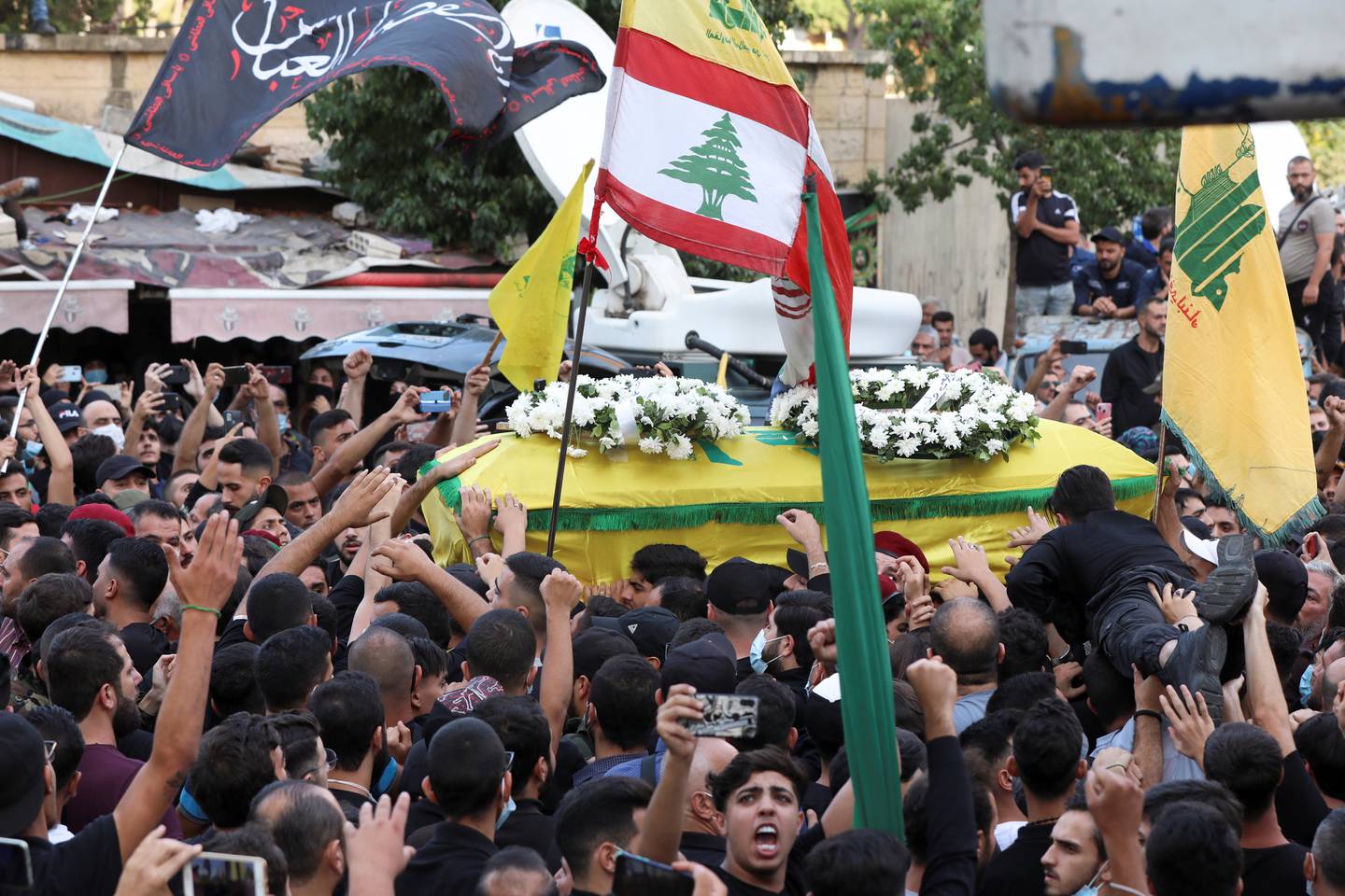 Supporters of Lebanon's Hezbollah carry a coffin of a person who was killed in violence in Beirut on Thursday, during a funeral in Beirut's southern suburbs. Reuters