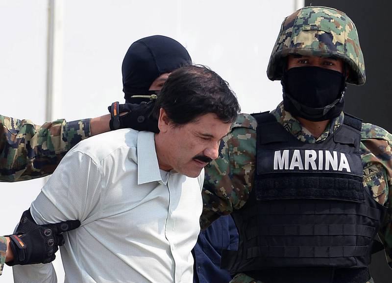 (FILES) In this file photo taken on February 22, 2014, Mexican drug trafficker Joaquin Guzman Loera, aka "El Chapo" Guzman, is escorted by marines as he is presented to the press in Mexico City.  Mexican drug kingpin Joaquin "El Chapo" Guzman's defense team on January 31, 2019 urged a US jury not to believe "garbage" testimony of government witnesses, insisting their client was not the real mastermind of the Sinaloa cartel. The 14 ex-associates of Guzman who took the stand during the trial in a federal courtroom in Brooklyn did so to get reduced sentences, attorney Jeffrey Lichtman told the jury. "Those witnesses not only admitted to lying every day of their lives, their miserable, selfish lives -- they lied to you here in the courtroom," he said.

 / AFP / Alfredo ESTRELLA
