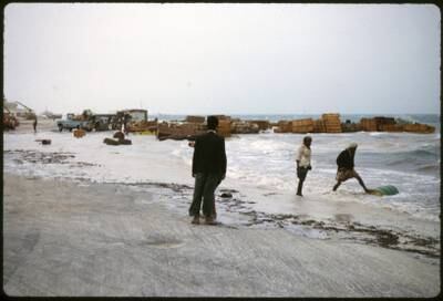 Abu Dhabi town 1962/64 On the sea front near the quay. Recently unloaded cargo caught by a Winter storm and high tide, when the sea 'surged' inshore. Photo by David Riley