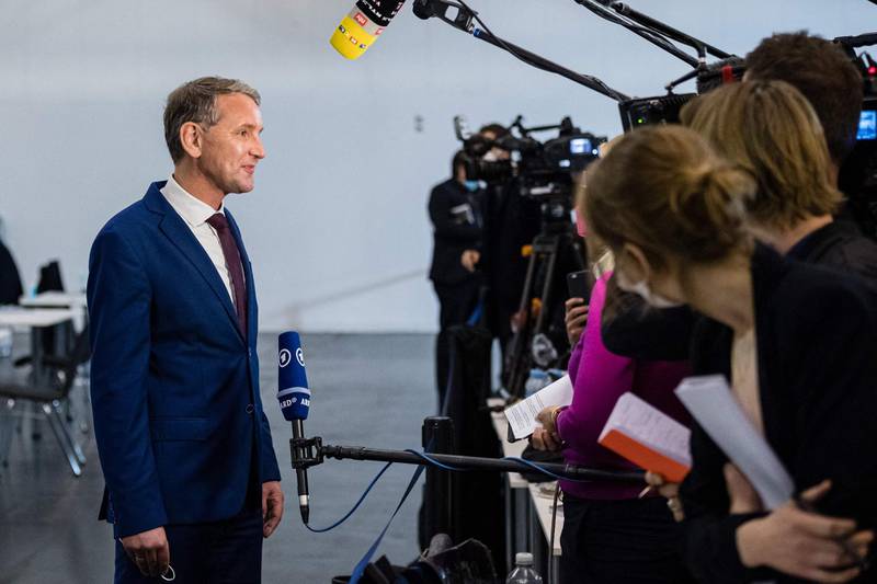 Bjoern Hoecke of the far-right Alternative for Germany (AfD) gives a TV interview during a congress of far-right Alternative for Germany (AfD - Alternative fuer Deutschland) party in Dresden, eastern Germany, on April 10, 2021.  The far-right AfD will firm up its election manifesto this weekend as Germany prepares for the post-Merkel era, with the party seeking to reverse a lag in support amid infighting and an ailing effort to capitalise on the pandemic.  / AFP / JENS SCHLUETER
