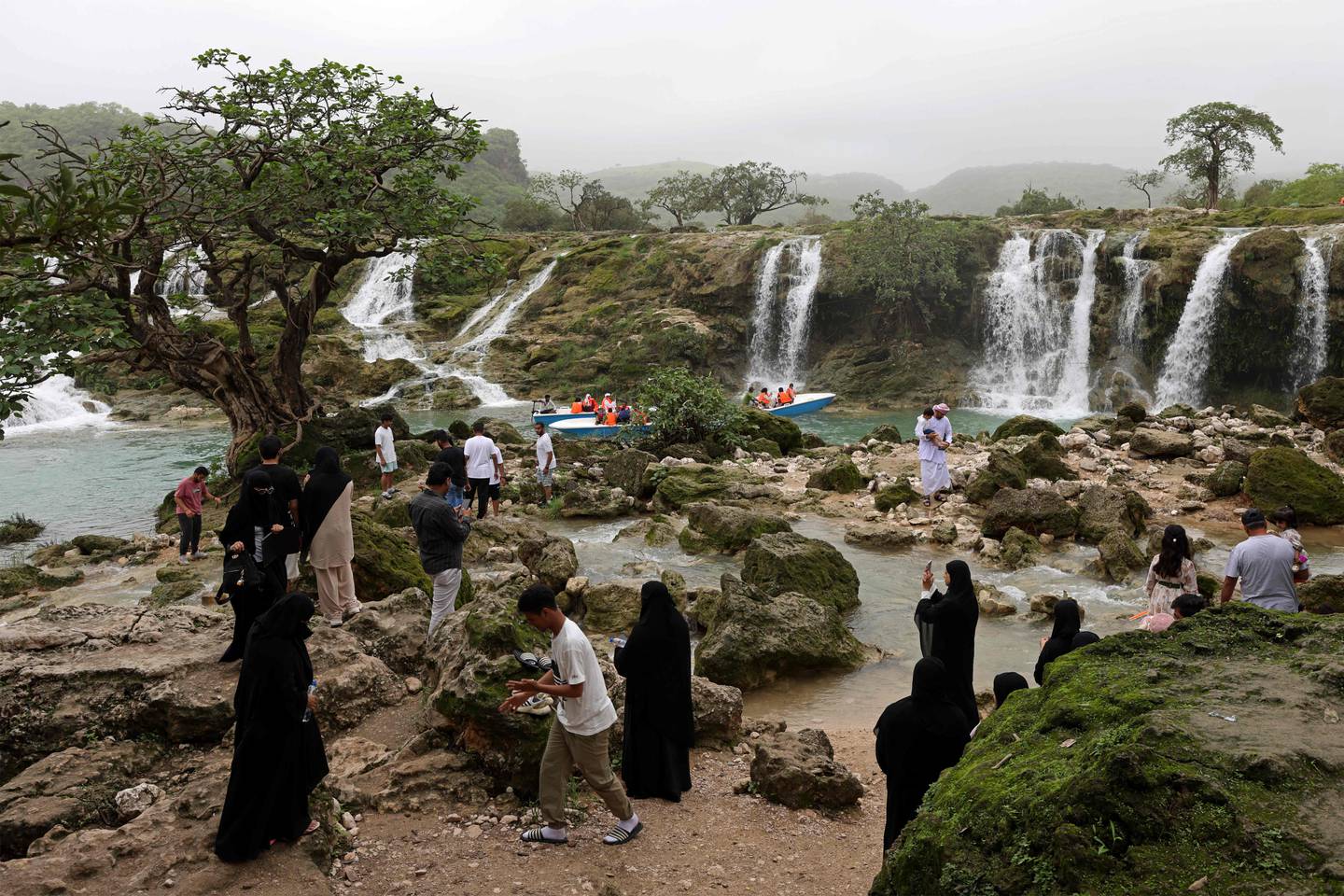 Locals and tourists tour the Wadi Darbat (Darbat Valley) near Salalah, in the southern Omani province of Dhofar.  AFP