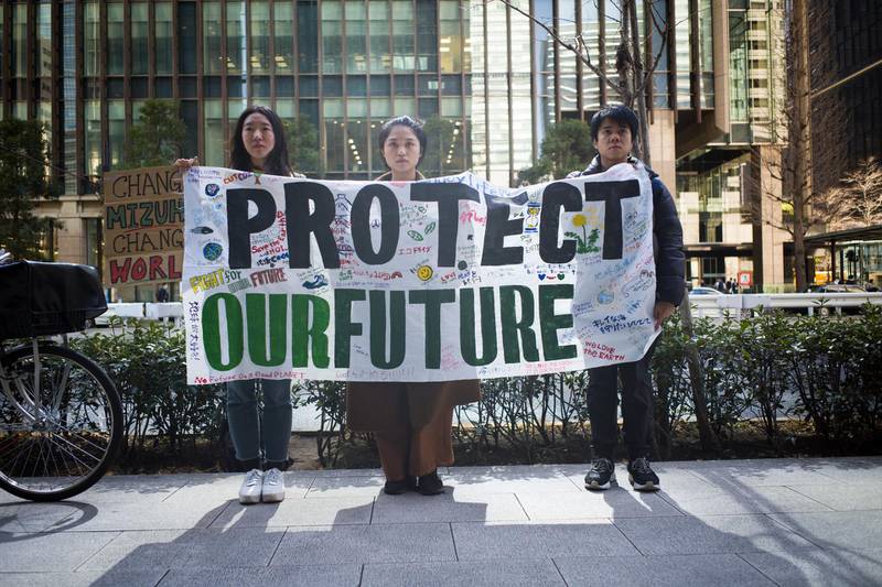 A group of youth climate activists display a protest banner outside the Mizuho Financial Group Inc. headquarters in Tokyo, Japan, on Friday, March 6, 2020. The anti-coal demonstration organized by Fridays for Future Tokyo denounced Mizuho Bank's role in financing coal projects globally. Photographer: Kentaro Takahashi/Bloomberg