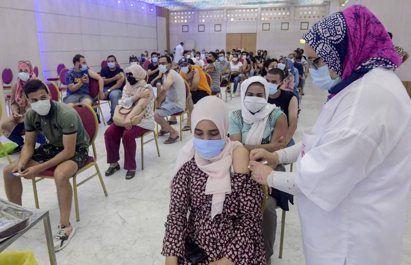 A woman receives a dose of the Sinopharm vaccine at the Palais des Congres in Tunis.