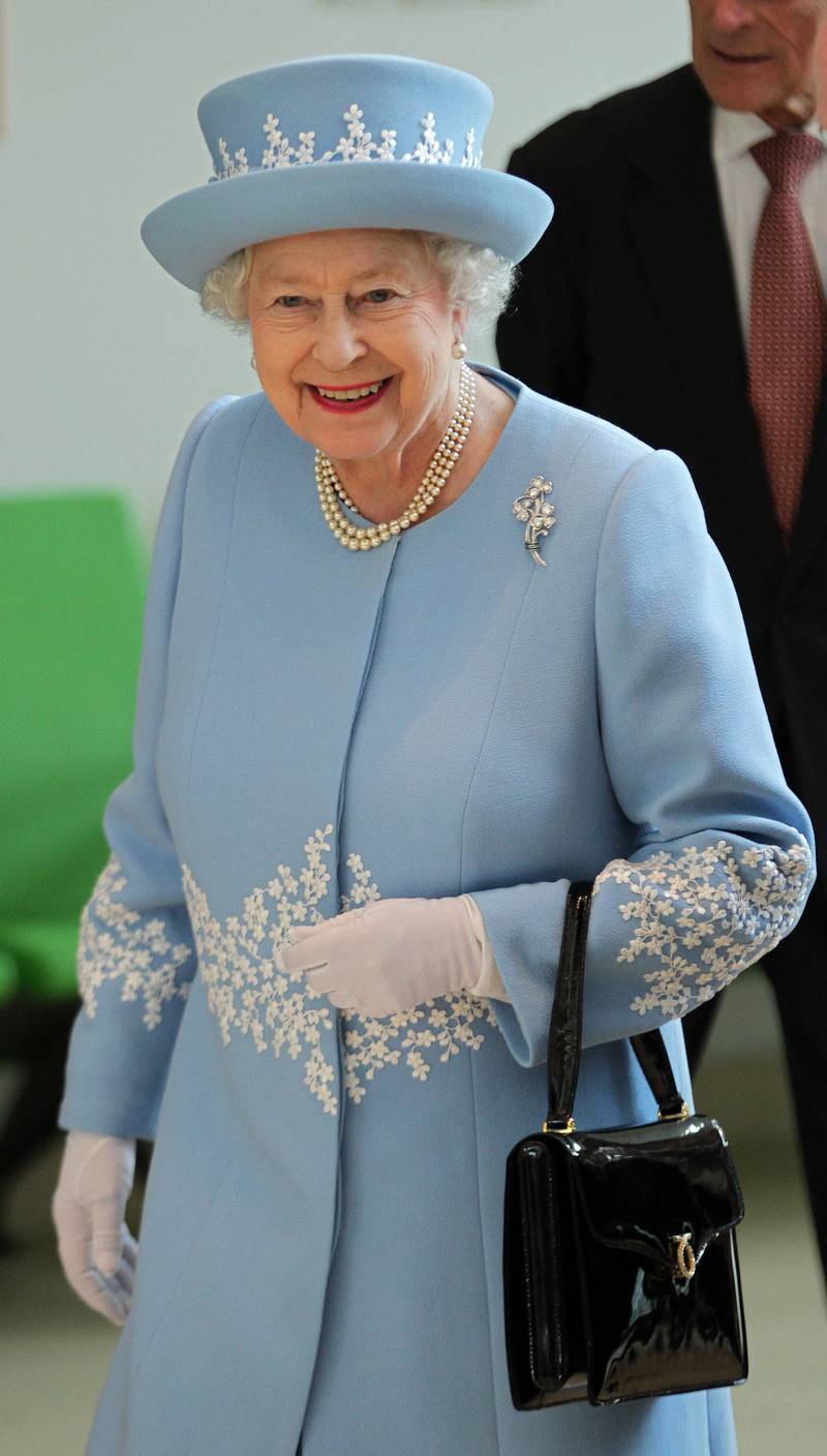 Queen Elizabeth II wears the diamond shamrock brooch, gifted to her by the late Sultan Qaboos bin Said of Oman to celebrate her diamond jubilee, during a visit to Northern Ireland in June 2012. AFP