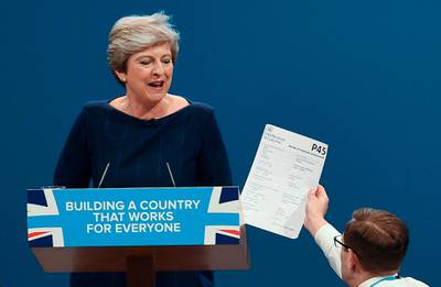 Comedian Simon Brodkin, right, givesBritain's Prime Minister Theresa May her P45 (UK's employee leaving form) during the Conservative Party annual conference in Manchester. Paul Ellis / AFP Photo / October 4, 2017