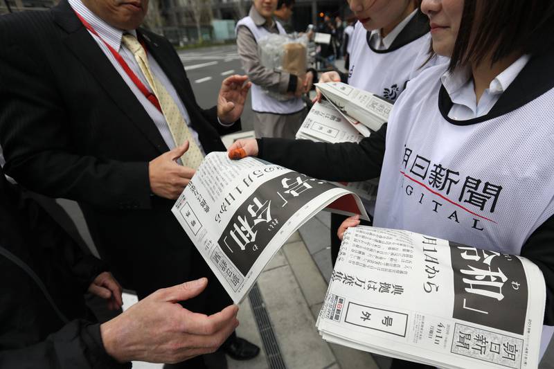 Vendors hand out special editions of the Asahi Shimbun newspaper featuring reports on the announcement of the name of Japan's next imperial era "Reiwa" in Tokyo, Japan. Bloomberg