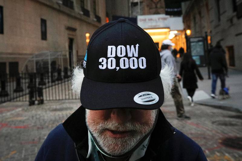 Trader Peter Tuchman wears a DOW 30,000 hat as he greets friends outside the New York Stock Exchange (NYSE) in New York, U.S., November 24, 2020. REUTERS/Brendan McDermid