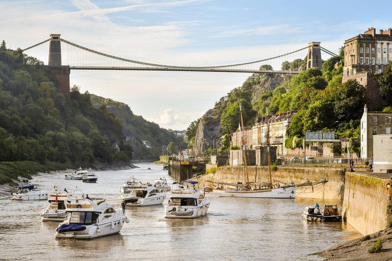 Boats make their way through the Avon Gorge and underneath Clifton Suspension Bridge as they head to Bristol harbour for the Bristol Harbour Festival, where hundreds of vessels from tall ships to dinghies will gather in the city centre floating harbour. (Photo by Ben Birchall/PA Images via Getty Images)