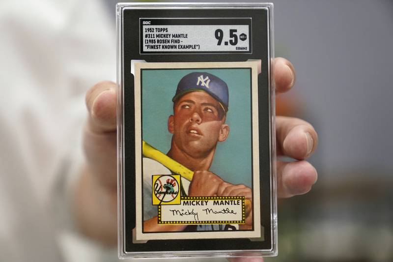 A mint condition Mickey Mantle baseball card was sold for a record $12.6 million during auction. AP