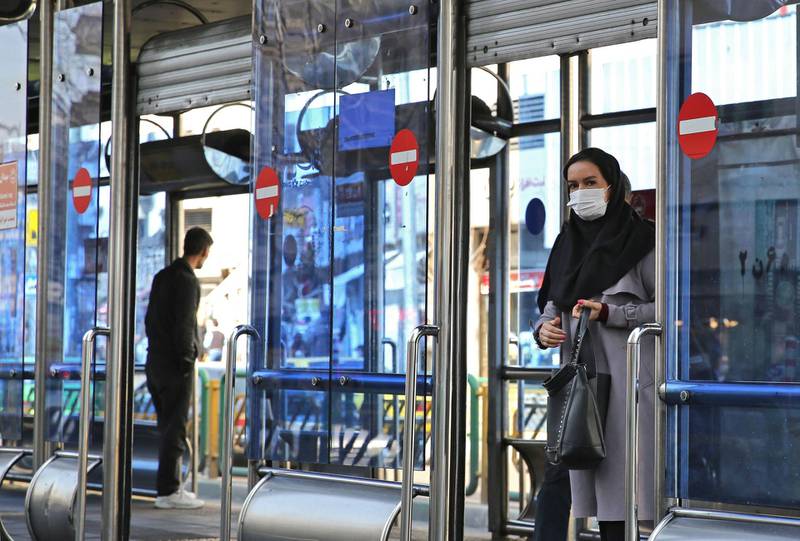 An Iranian woman wears a protective mask in the capital Tehran has scrambled to halt the rapid spread of the COVID-19 virus, shutting schools and universities.  AFP