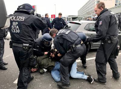 German police arrests a demonstrator in Duesseldorf.  Britta Radike / dpa / AFP Photo
