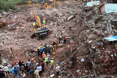 Rescue workers search for survivors in the rubble of a collapsed five-storey apartment building in the town of Mahad, about 170 kilometres south of India's financial capital of Mumbai.  AFP