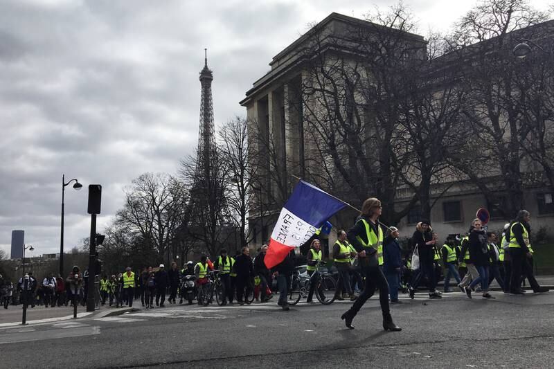 Yellow vest protesters walk past the Eiffel Tower in March 2019.