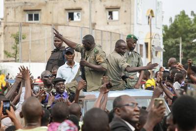 Crowds cheer as soldiers parade in vehicles along the Boulevard de l'Independance in Bamako, Mali. Getty Images