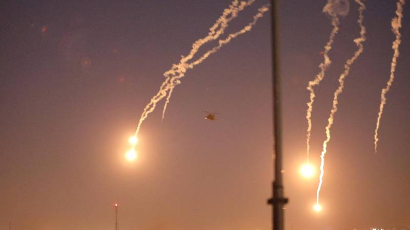 US Apache helicopters launch flares as they conduct overflights of the US embassy in Baghdad. Reuters