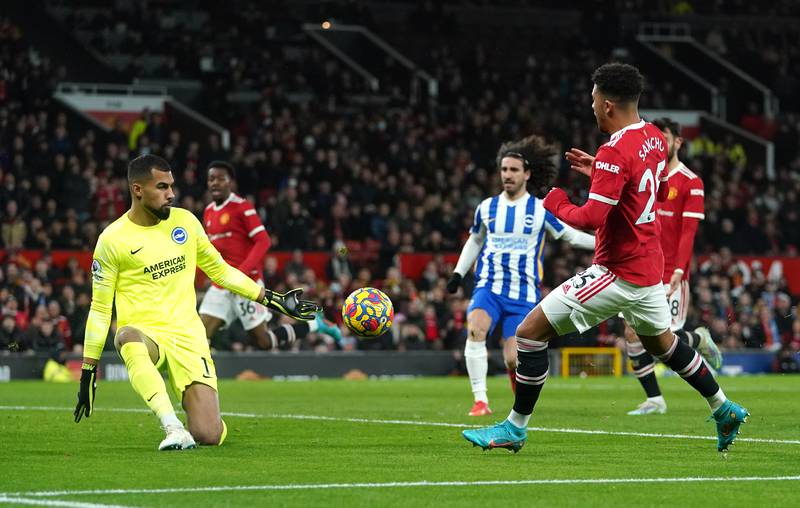 Manchester United's Jadon Sancho sees a first-half shot saved by Brighton goalkeeper Robert Sanchez. PA