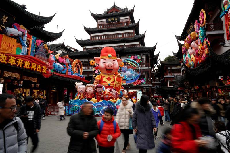 People walk by a giant decoration in the shape of a pig ahead of the upcoming Chinese Lunar New Year in Yu Yuan Garden in Shanghai, China January 31, 2019. REUTERS/Aly Song