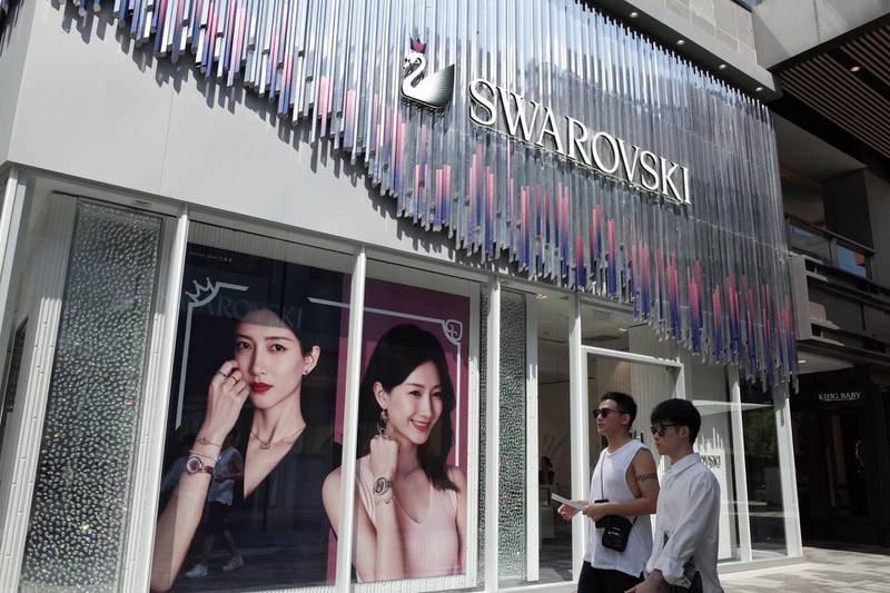 epa07770729 People walk pass by a Swarovski store in a commercial district in Beijing, China, 13 August 2019. Fashion brands Versace and Coach apologize to Chinese customers after social media users called for a boycott of the brands due to separate T-shirts from both fashion houses that suggested Hong Kong and Taipei were separate from China. And also Swarovski apologizes to Chinese customers for erroneously describing Hong Kong as a country on its website.  EPA/WU HONG