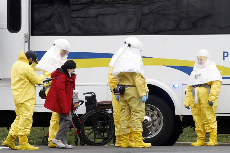 Medical officials aid a residents from St. Joseph's nursing home to board a bus, after a number of residents tested positive for coronavirus disease (COVID-19) in Woodbridge, New Jersey, U.S. REUTERS