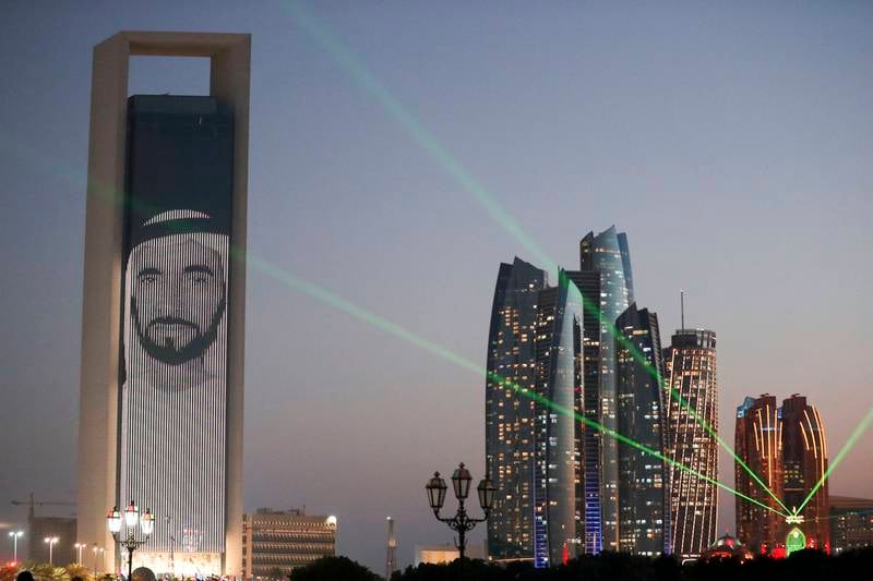 Abu Dhabi National Oil Company is lit up with different images of the country's leaders to mark the UAE's Golden Jubilee. Khushnum Bhandari / The National