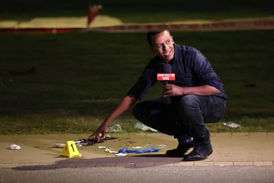 A reporter on the crime scene in Tel Aviv. One man was killed and five people were wounded in the attack. AFP
