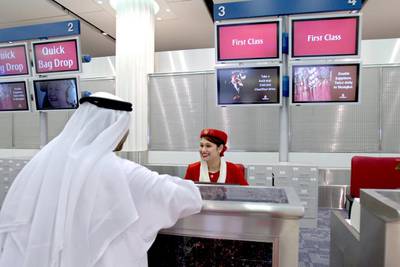 Dubai International Airport has hired extra staff for the Eid holiday rush. Above, an Emirates Airline ground staff checks in a guest. Ali Haider / EPA