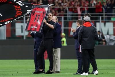 Zlatan Ibrahimovic is presented with his framed AC Milan shirt after the match against Hellas Verona. Getty Images