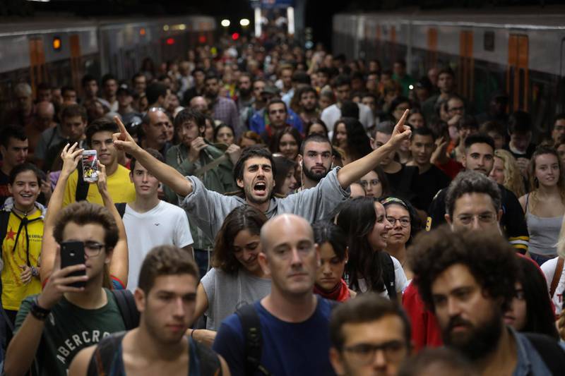 A man shouts slogans as people arrive at Plaza Catalunya station during a partial regional strike called by pro-independence parties and unions in Barcelona, Spain, October 3, 2017. REUTERS/Susana Vera     TPX IMAGES OF THE DAY