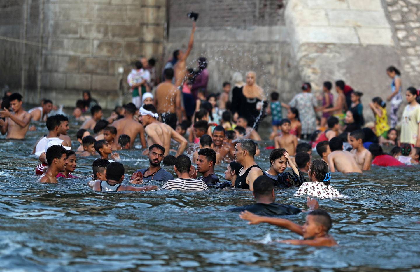 People swim in the Nile River during hot weather in Al-Qanater on the outskirts of Cairo in August. Reuters