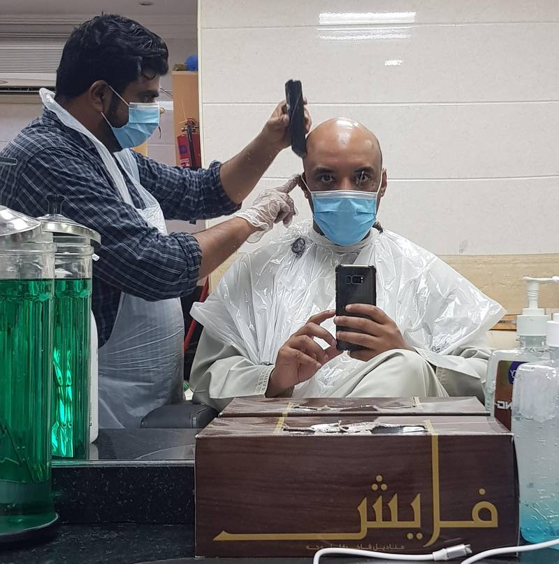 Barber Zein Abideen gives Saeed Saeed his long overdue haircut. Courtesy Saeed Saeed 